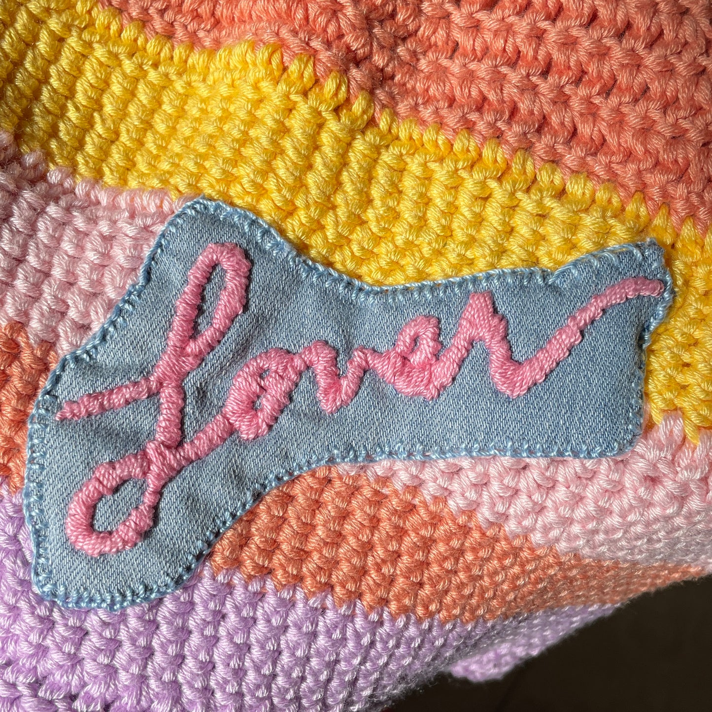 Embroidered word "lover" on multicolored beanie.  Inspired by Taylor Swift album of the same name.